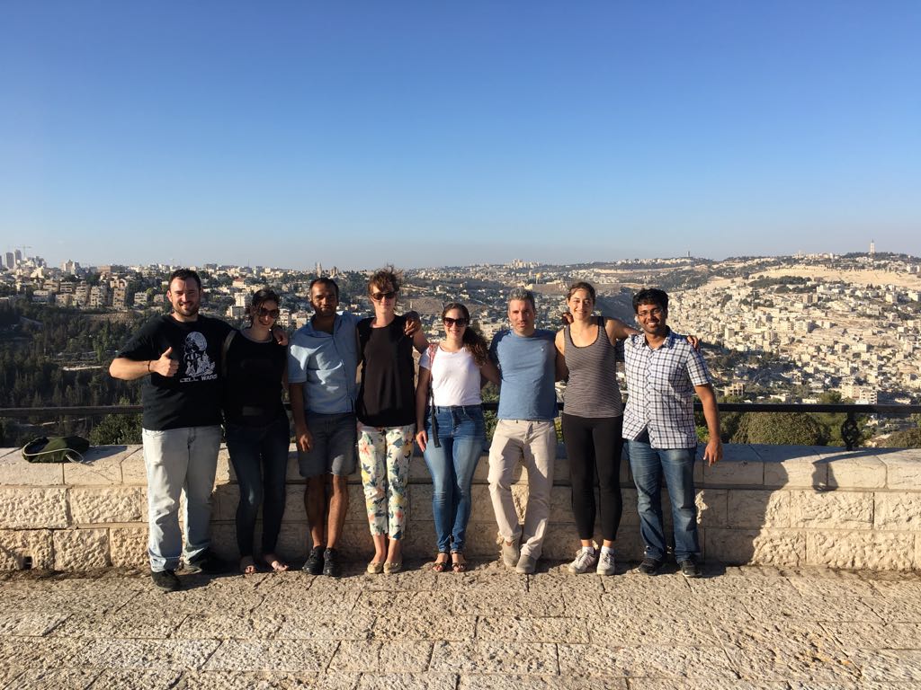 Group photo from a Molecular Cell Biology Department retreat at the Mount of Olives in Jerusalem, showing Dr. Amit Agrawal, Dr. Yossi Ovadya, Dr. Julia Magdalena Majewska, Dr. Nurit Cohen, Dr. Lior Roitman, and Dr. Hilah Gal from the Prof. Valery Krizhanovsky Lab, Weizmann Institute of Science.