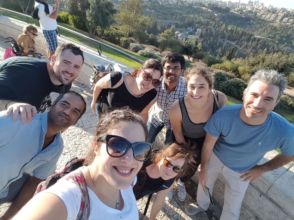 Group photo from a Molecular Cell Biology Department retreat at the Mount of Olives in Jerusalem, showing Dr. Amit Agrawal, Dr. Yossi Ovadya, Dr. Julia Magdalena Majewska, Dr. Nurit Cohen, Dr. Lior Roitman, and Dr. Hilah Gal from the Prof. Valery Krizhanovsky Lab, Weizmann Institute of Science.
